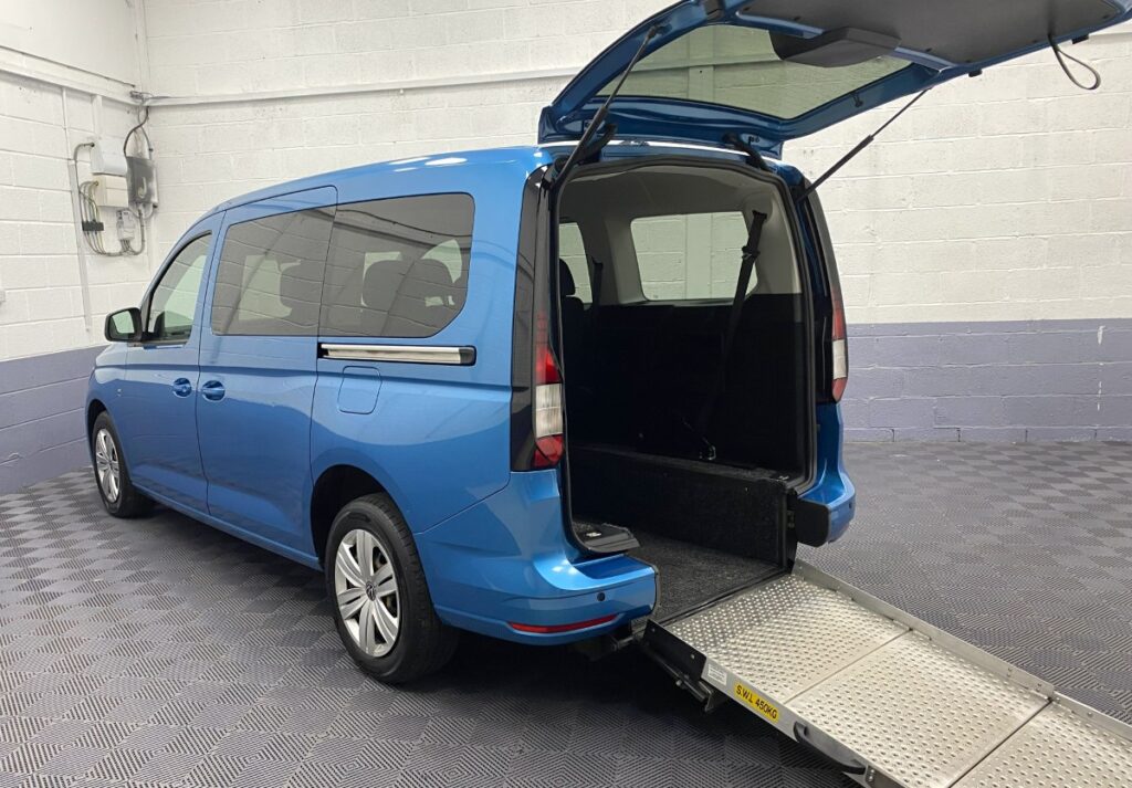 2022 Volkswagen Caddy Maxi Petrol wheelchair accessible vehicle rear three quarter view with wheelchair ramp deployed NK72AUL