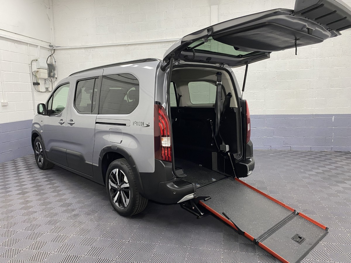 A Peugeot Rifter LWB Automatic Wheelchair Accessible Vehicle rear three quarter view with the wheelchair ramp deployed SB24MJY