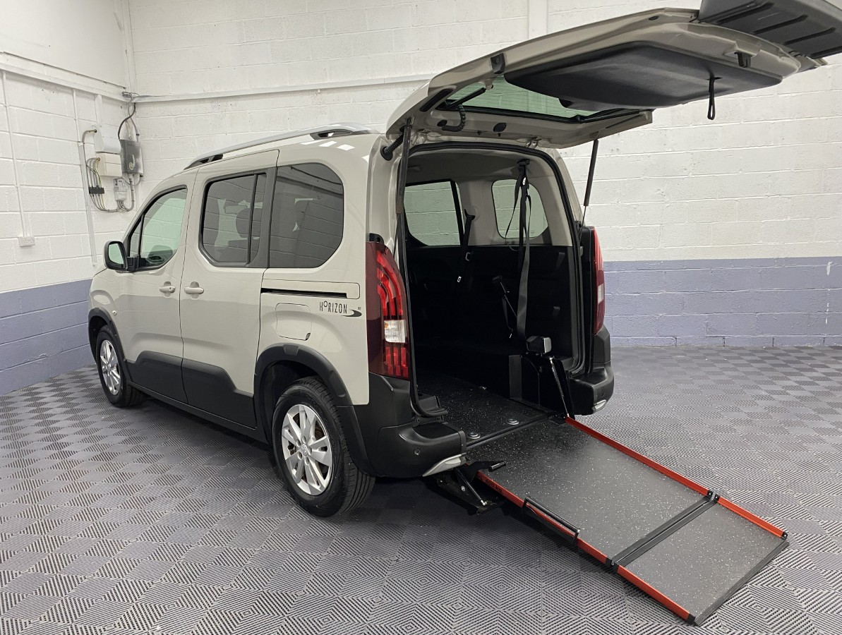 A wheelchair accessible Peugeot Rifter rear three quarter view with the wheelchair ramp deployed SF69HMG